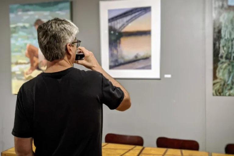 A person viewing art at a Jazz Forum art exhibit