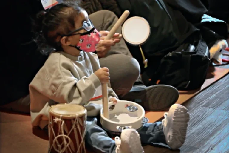 Child with drums playing during a Jitterbugs - Jazz for Kids class
