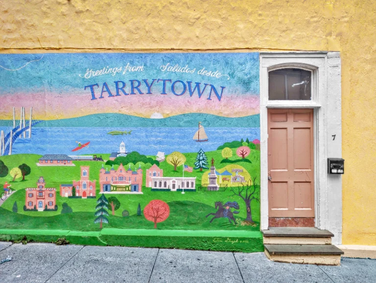 A mural in Tarrytown with the city painted on it, next to Main Street on a street leading to the Jazz Forum